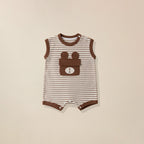 Striped baby romper with bear design pocket on a beige background