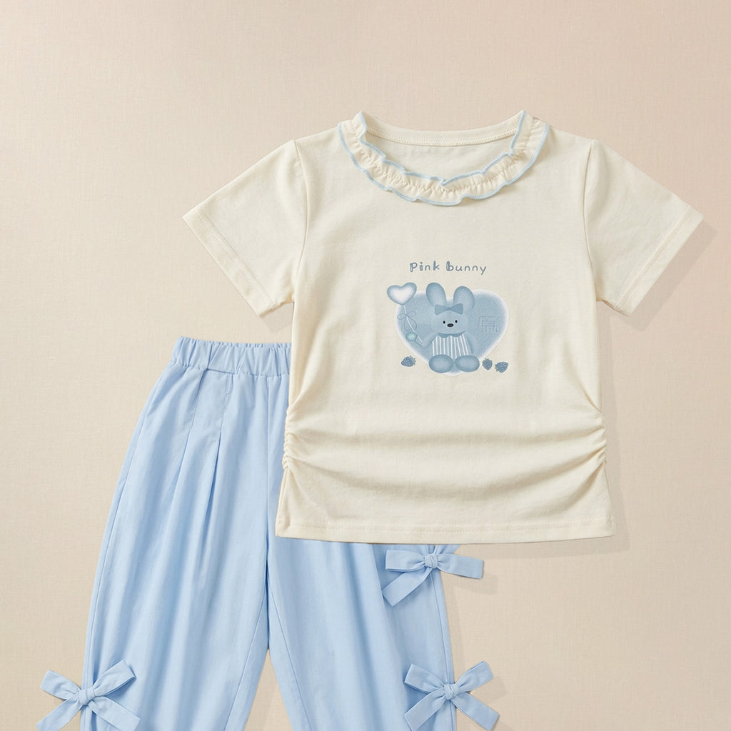 Close-up of bunny graphic print on girls' cream ruffle collar t-shirt 
