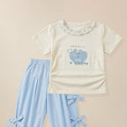 Close-up of bunny graphic print on girls' cream ruffle collar t-shirt 