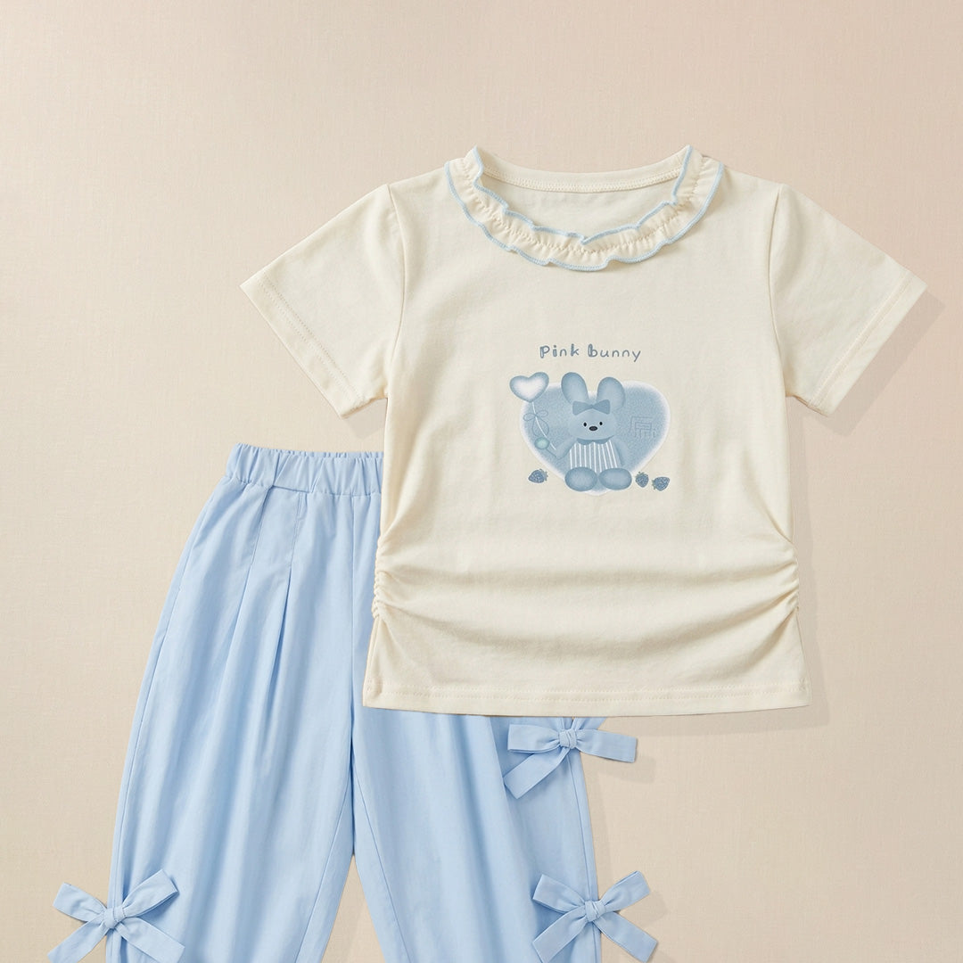 Close-up of bunny graphic print on girls' cream ruffle collar t-shirt 