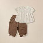Back view of scalloped collar top and brown pants co-ord set