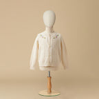 Ivory cable knit cardigan with floral embroidery on mannequin display