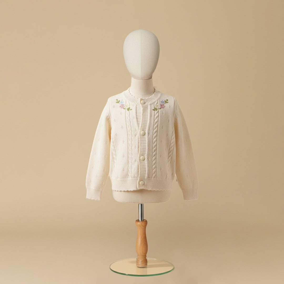 Ivory cable knit cardigan with floral embroidery on mannequin display