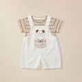 Children's outfit with white dungaree shorts featuring a cartoon dog design paired with strip t-shirt.
