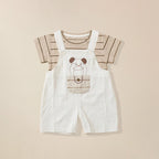 Children's outfit with white dungaree shorts featuring a cartoon dog design paired with strip t-shirt.