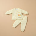 Sunny yellow quilted baby jacket and pants set with elephant print, flat lay