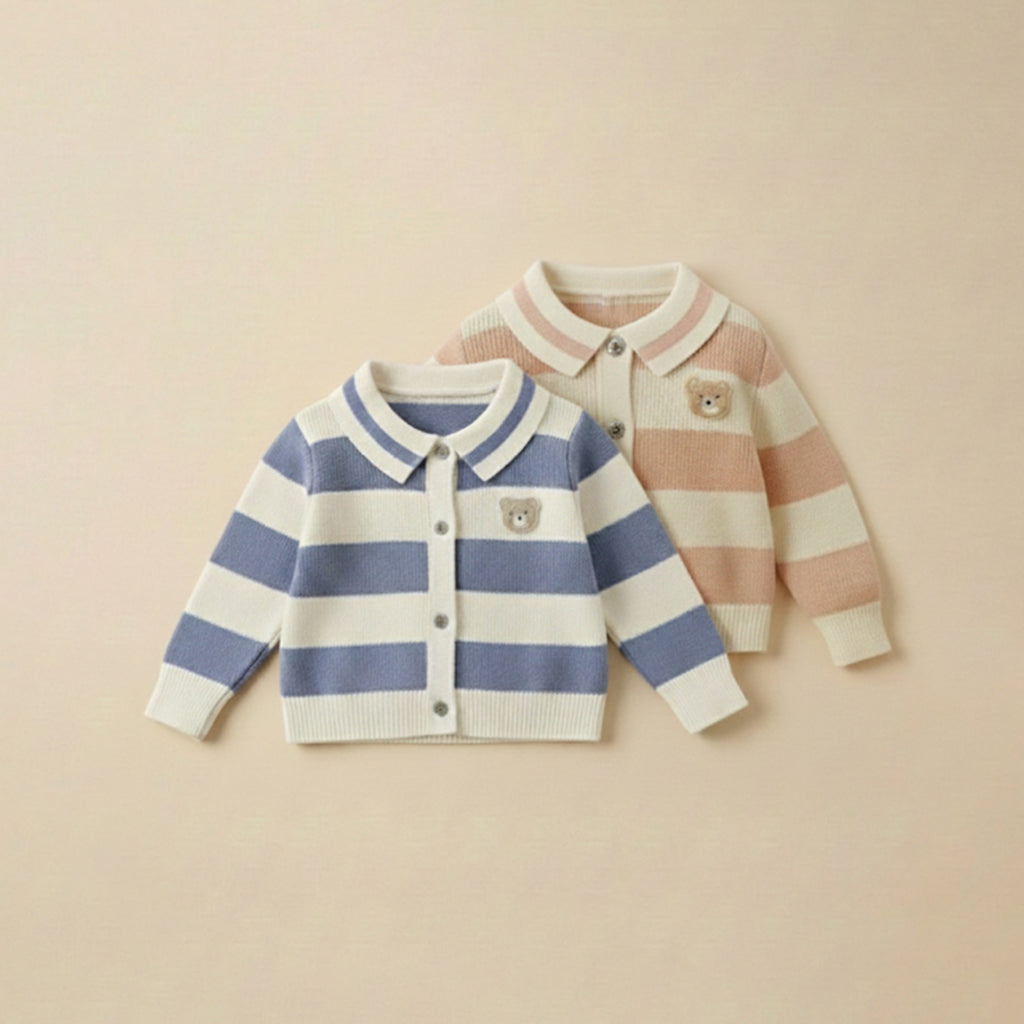 Two children's cardigans, one striped blue and white, the other striped pink and white, on a beige background.