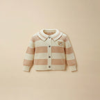 Pink and cream striped cardigan with teddy bear patch, flat lay