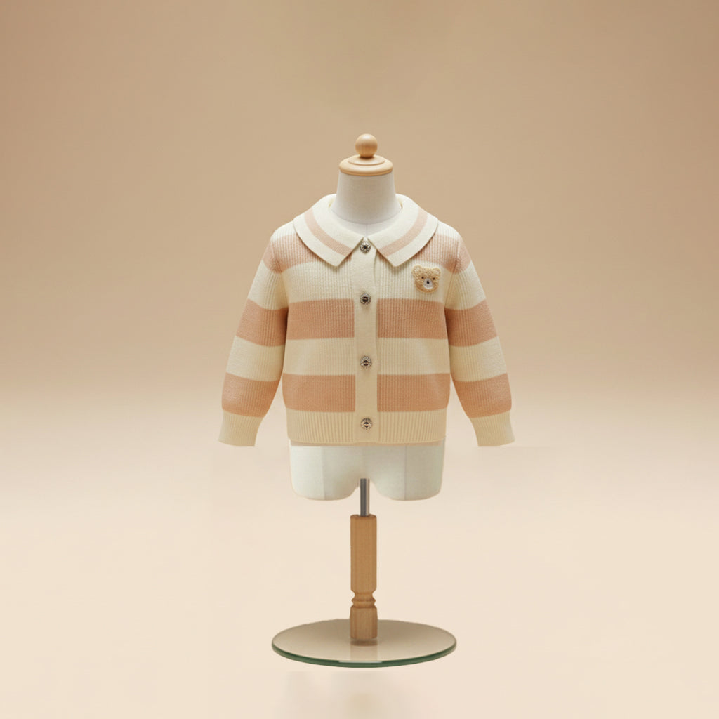 Pink and cream striped cardigan with collar and teddy patch on mannequin